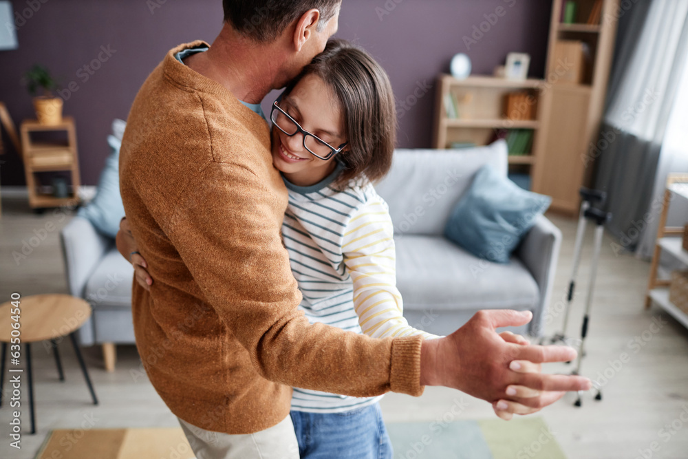 Φωτογραφία Portrait of smiling teenage girl with cerebral palsy slow dancing with father in