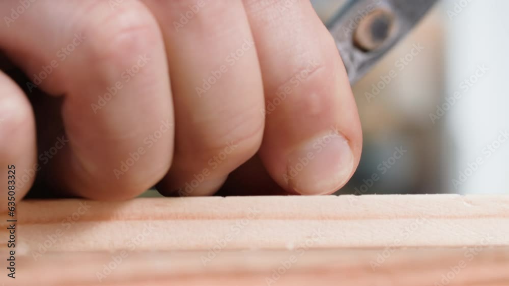 repair, male builder using a hammer hammers nails into a wooden board, close-up repair, male builder using a hammer hammers nails into a wooden board, close-up