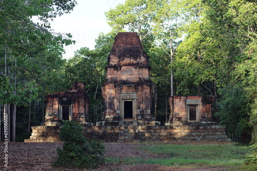 Cambodia. Prasat Bei is a temple with three brick towers in a north-south row, facing to the east, and standing on a laterite platform. The central tower contained a linga.