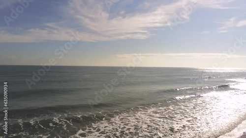 Seaside Soar: Drone Captures Woman's Tranquil Beach Walk