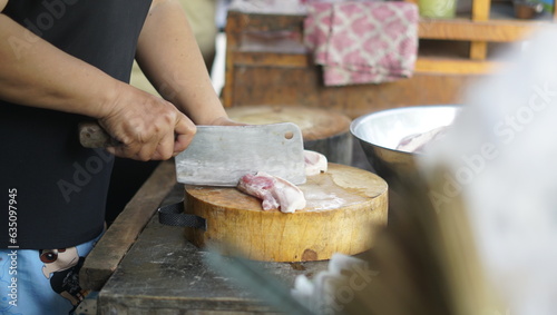 Chef preparing food. Cut the pork prepare to cook.