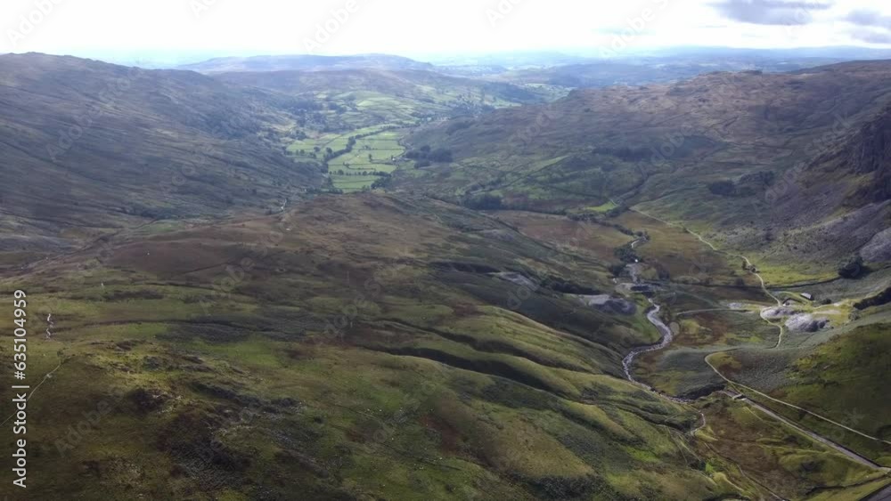 View of the mountain lake with fog and low clouds moving across it The National park Lake District. Aerial shot View of the mountain lake with fog and low clouds moving across it The National park Lake District. Aerial shot