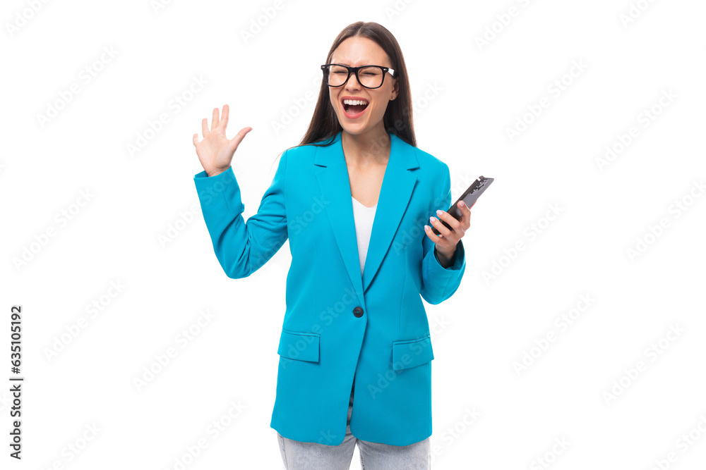 stylish young brunette businesswoman in a blue jacket solves work issues by phone isolated on white background with copy space stylish young brunette businesswoman in a blue jacket solves work issues by phone isolated on white background with copy space