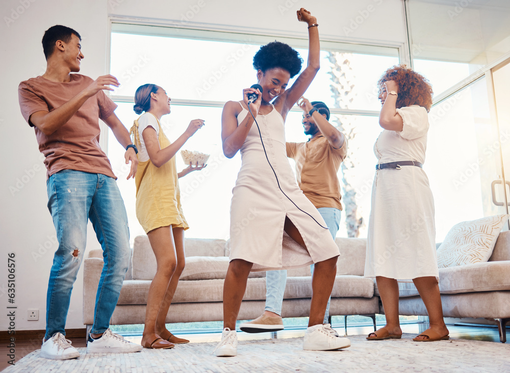 Happy, party and people singing karaoke in the living room with a microphone to music, playlist or radio. Entertainment, diversity and young friends dancing, bonding and having fun together at home. Happy, party and people singing karaoke in the living room with a microphone to music, playlist or radio. Entertainment, diversity and young friends dancing, bonding and having fun together at home.