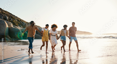 Summer  friends and people happy at sunset beach for fun  holding hands and travel with love. Diversity  men and women group in nature with sand  freedom and happiness on a vacation or holiday