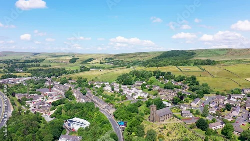 Aerial footage of the beautiful British town of Haslingden in Rossendale, Lancashire, England showing the small town from above on a hot sunny day in the summer time photo
