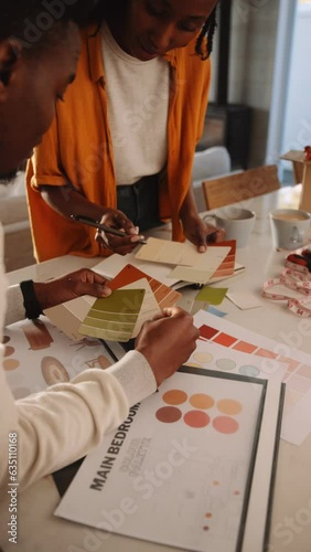 A Black Couple Selecting Colors from a Swatch 