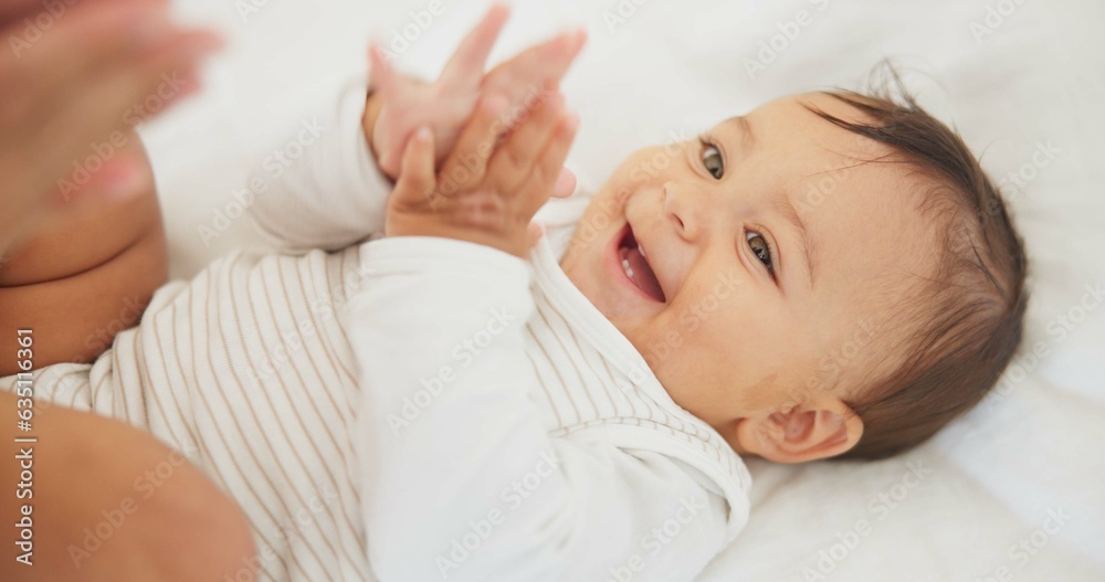 Infant baby, clapping hands and bed with parent, care or learning with smile, love or childhood development. Young happy kid, nursery or bedroom with teaching, applause or excited face in family home Infant baby, clapping hands and bed with parent, care or learning with smile, love or childhood development. Young happy kid, nursery or bedroom with teaching, applause or excited face in family home