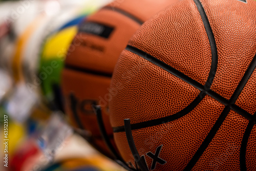 Basketballs on the rack of sports retail store, in sports shop.