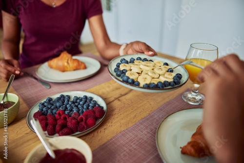 Close-up image of people having a healthy breakfast with berries  raspberries  and bananas.