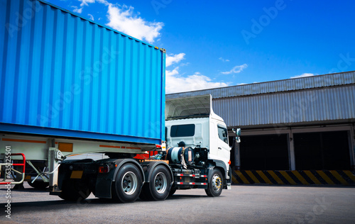 Semi trailer Truck on The Parking Lot at Warehouse. Shipping Warehouse. Handling of Logistics Transportation Industry. Cargo Container ships, Freight Trucks Import-Export. Distribution Warehouse.