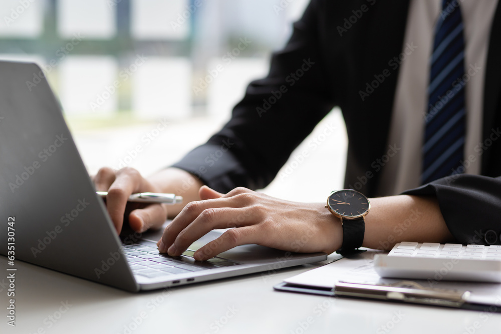 © Wasan - Close up businessman doing financial work on laptop and typing on keyboard. © Wasan - Close up businessman doing financial work on laptop and typing on keyboard.