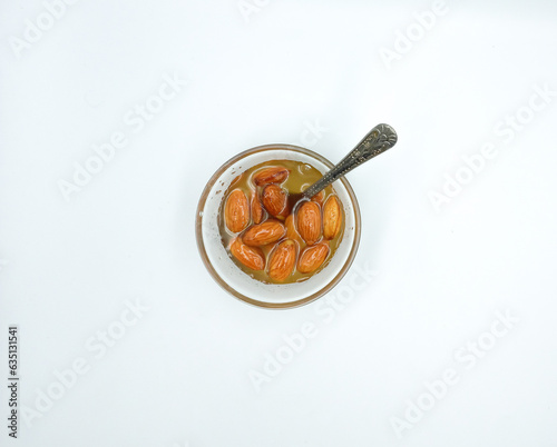 Honey with nuts almonds in a plate with a spoon