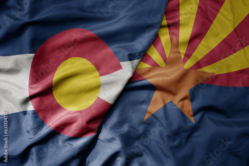 big waving colorful national flag of arizona state and flag of colorado state .