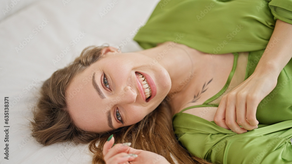 Young blonde woman smiling confident lying on bed at bedroom Young blonde woman smiling confident lying on bed at bedroom