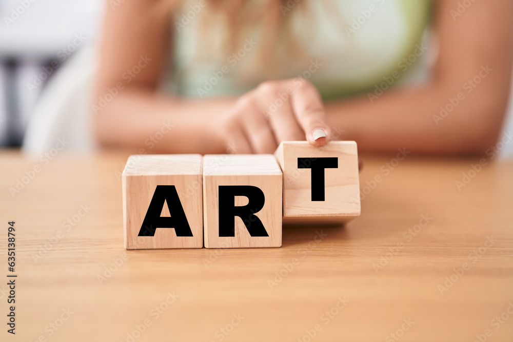 Naklejka premium Young woman holding cubes with art word on the table