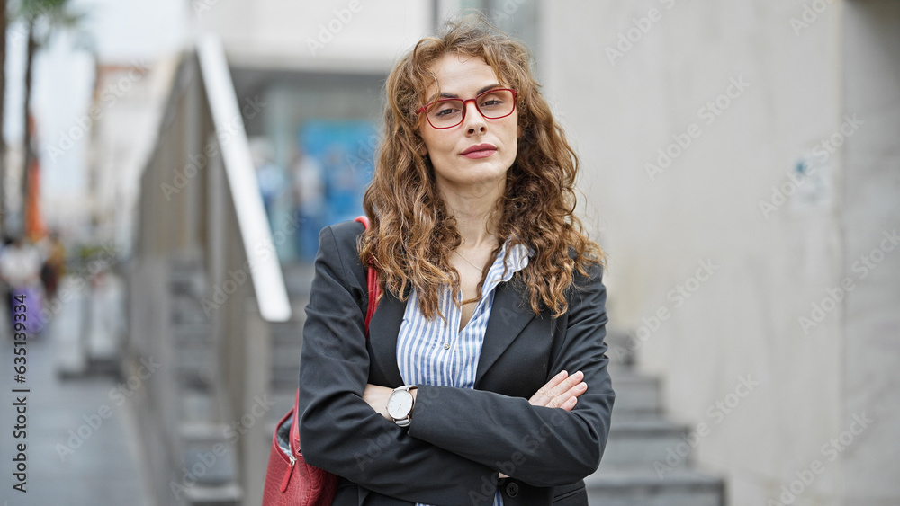 Young woman business worker standing with arms crossed gesture and serious face at street Young woman business worker standing with arms crossed gesture and serious face at street