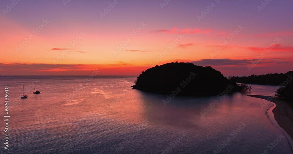 .aerial view amazing pink sky of sunset above Kala island at Layan beach Phuket..The reflection of sky on the ocean waters creates a stunning background.gradient colors. Kala island background.. .aerial view amazing pink sky of sunset above Kala island at Layan beach Phuket..The reflection of sky on the ocean waters creates a stunning background.gradient colors. Kala island background..