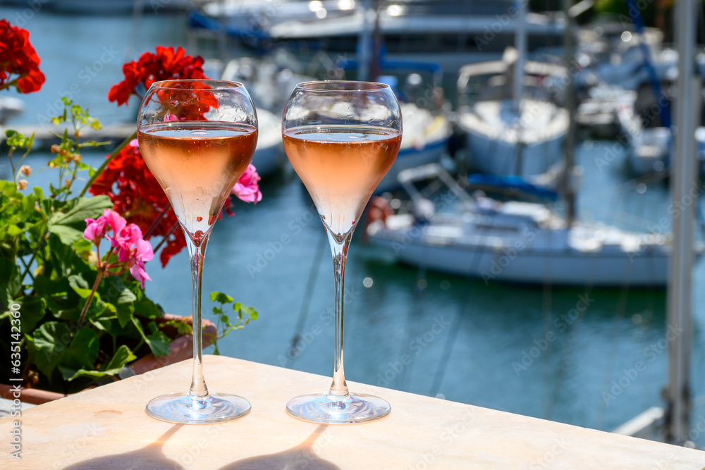 Summer party, drinking of French brut rose champagne sparkling wine in glasses in yacht harbour of Port Grimaud near Saint-Tropez, French Riviera vacation, France - obrazy, fototapety, plakaty 