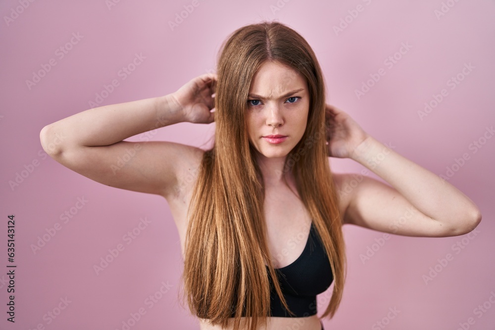 Young caucasian woman wearing lingerie over pink background skeptic and nervous, frowning upset because of problem. negative person. Young caucasian woman wearing lingerie over pink background skeptic and nervous, frowning upset because of problem. negative person.