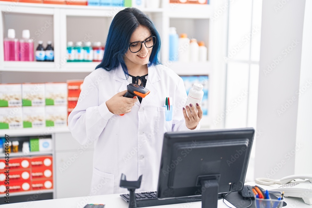 Young caucasian woman pharmacist scanning pills bottle at pharmacy