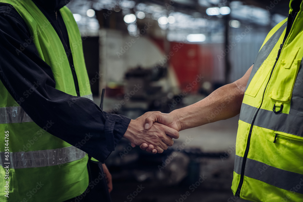 Close up hand of Engineer shaking hands. Industrial worker in the factory. Engineer is maintaining in the warehouse. Close up hand of Engineer shaking hands. Industrial worker in the factory. Engineer is maintaining in the warehouse.