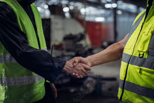 Close up hand of Engineer shaking hands. Industrial worker in the factory. Engineer is maintaining in the warehouse.