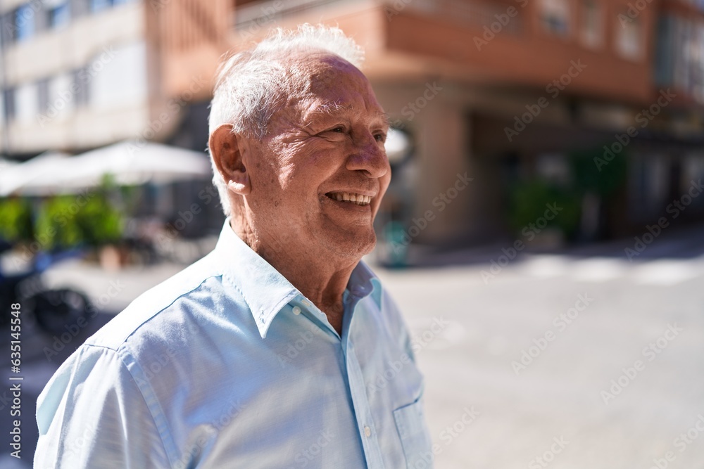 Middle age grey-haired man smiling confident looking to the side at street Middle age grey-haired man smiling confident looking to the side at street