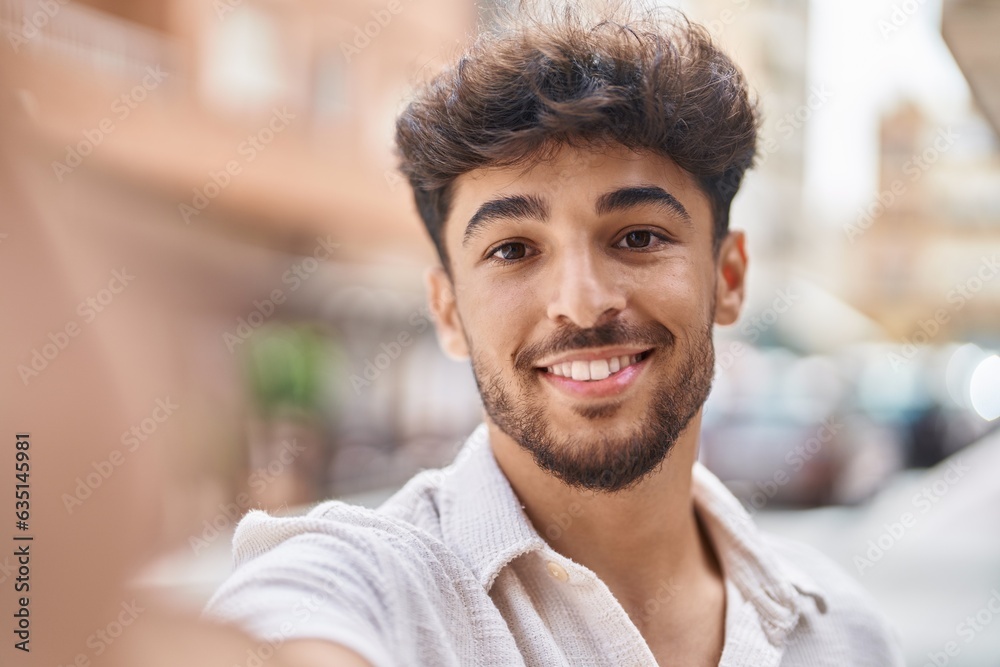 Young arab man smiling confident making selfie by the camera at street Young arab man smiling confident making selfie by the camera at street