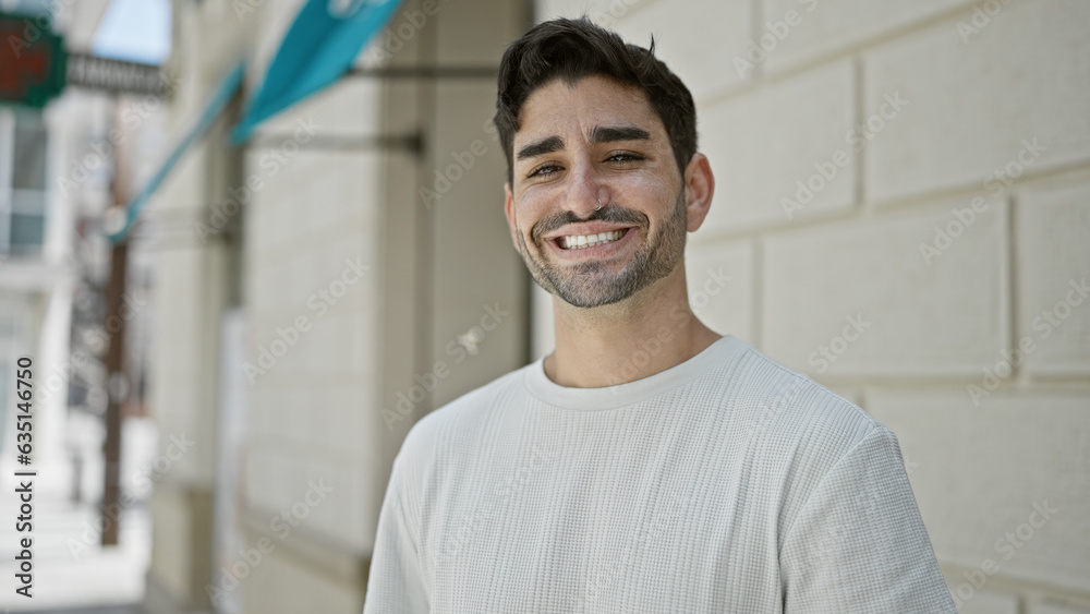 Young hispanic man smiling confident standing at street Young hispanic man smiling confident standing at street