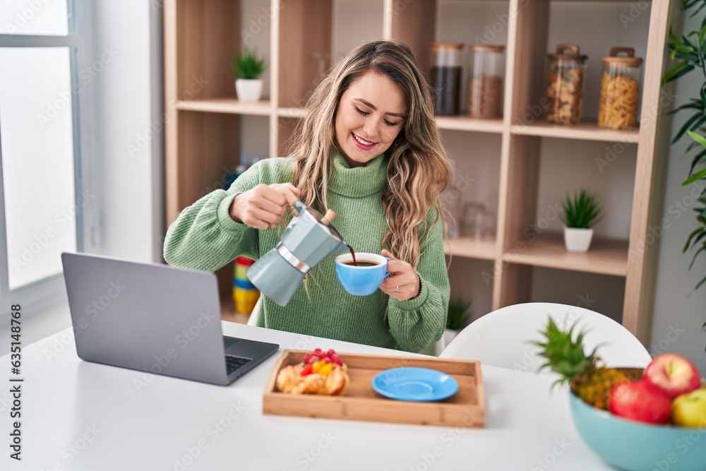 Young woman using smartphone having breakfast at home Young woman using smartphone having breakfast at home