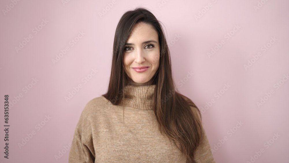 Beautiful hispanic woman smiling confident standing over isolated pink background Beautiful hispanic woman smiling confident standing over isolated pink background