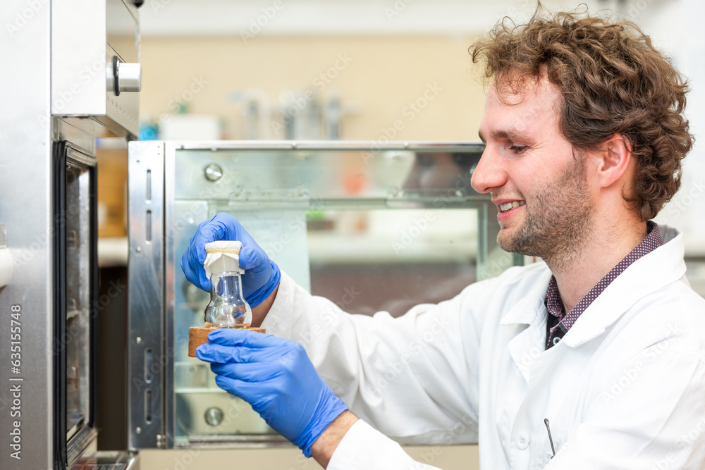 Young scientist in a research laboratory creating a scientific experiment, laboratory concept Young scientist in a research laboratory creating a scientific experiment, laboratory concept