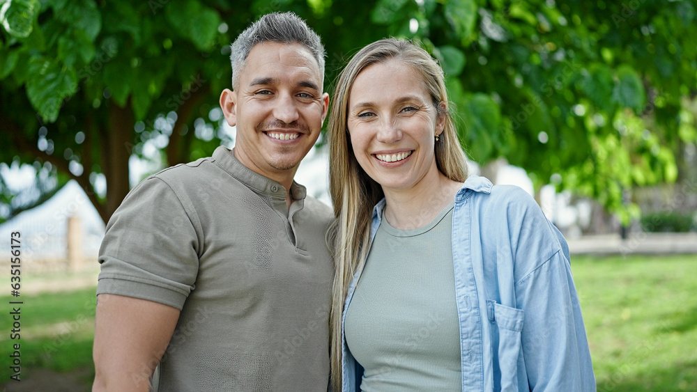 Man and woman couple smiling confident standing together at park Man and woman couple smiling confident standing together at park