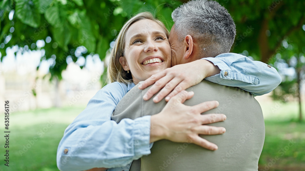 Man and woman couple hugging each other smiling at park Man and woman couple hugging each other smiling at park