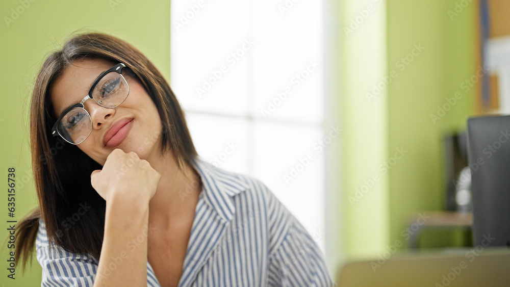Young caucasian woman business worker smiling confident sitting on table at office Young caucasian woman business worker smiling confident sitting on table at office