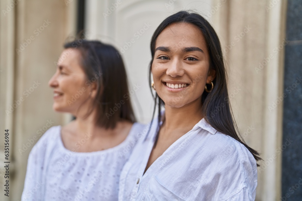 Two women mother and daughter smiling confident standing together at street Two women mother and daughter smiling confident standing together at street