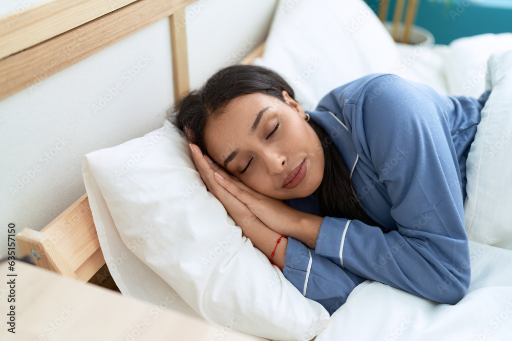 Young arab woman lying on bed sleeping at bedroom Young arab woman lying on bed sleeping at bedroom