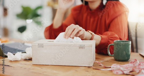 Tissue, blowing nose and sick Asian woman in office with sinus infection, virus and allergy symptoms. Business, corporate workplace and female worker at desk with cold, fever problem and flu sickness photo