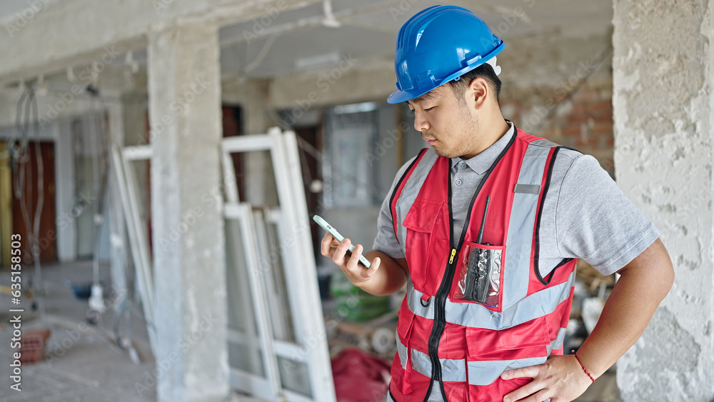  builder using smartphone at construction site