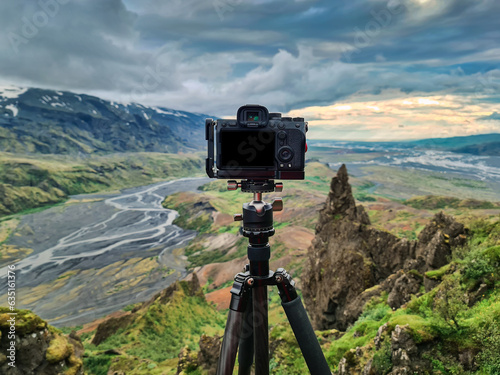 Mirrorless camera standing on tripod and taking photos at viewpoint of thorsmork valley