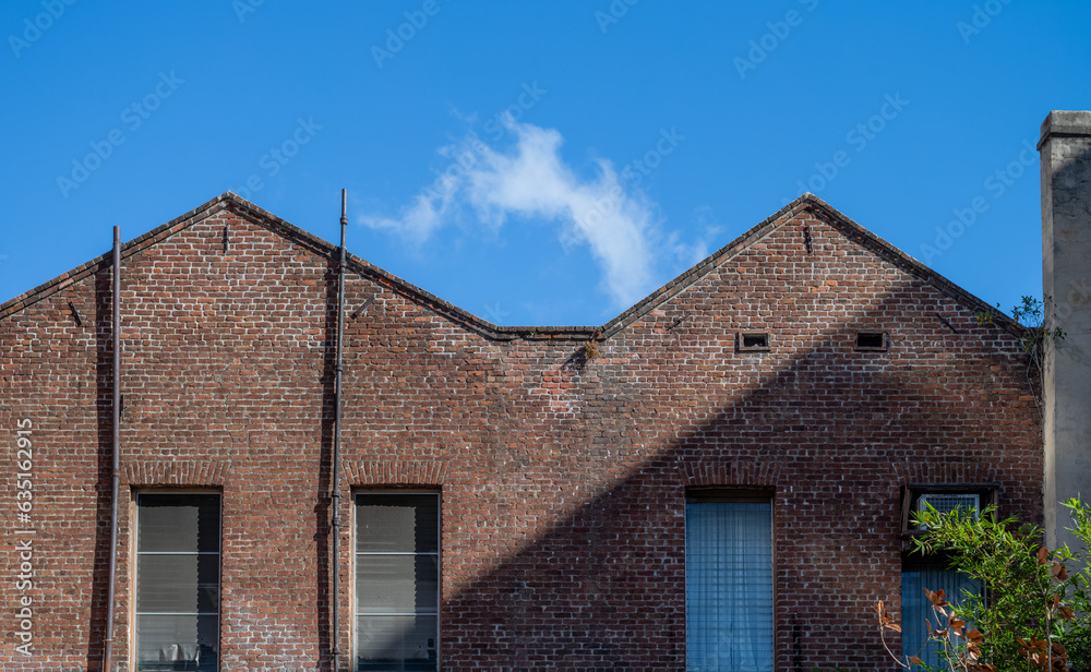 Abandoned Brick Foundry with Arched Roofs and Blue Sky Overhead. Abandoned Brick Foundry with Arched Roofs and Blue Sky Overhead.