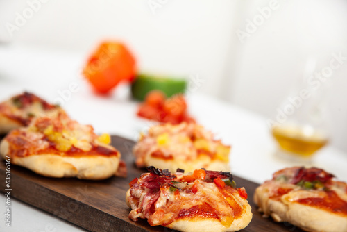 Delicious just baked homemade mini pizzas. Salami pizza.