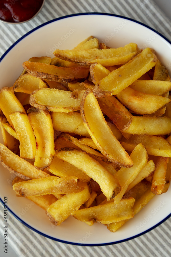 Homemade French Fries with Ketchup on a Plate, top view. Flat lay, overhead, from above. Homemade French Fries with Ketchup on a Plate, top view. Flat lay, overhead, from above.