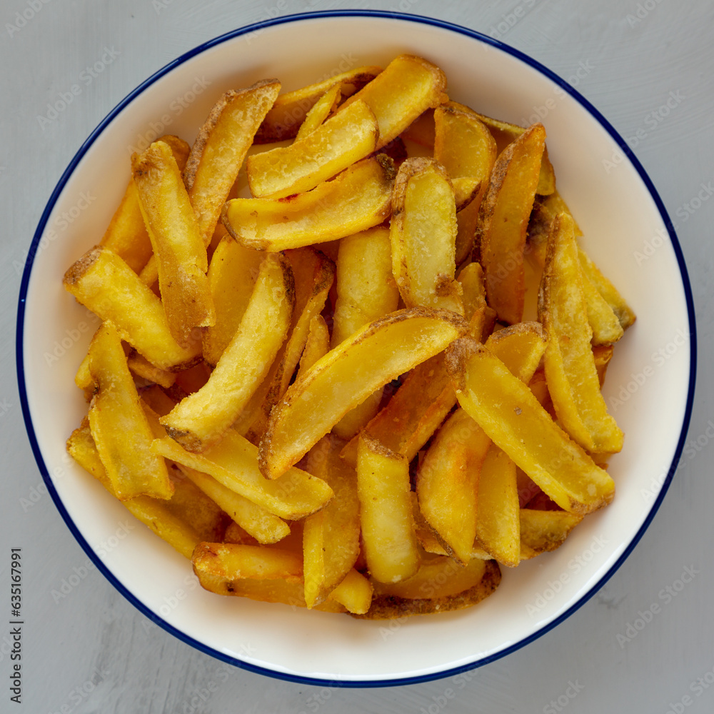 Homemade French Fries on a Plate, top view. Flat lay, overhead, from above. Close-up. Homemade French Fries on a Plate, top view. Flat lay, overhead, from above. Close-up.