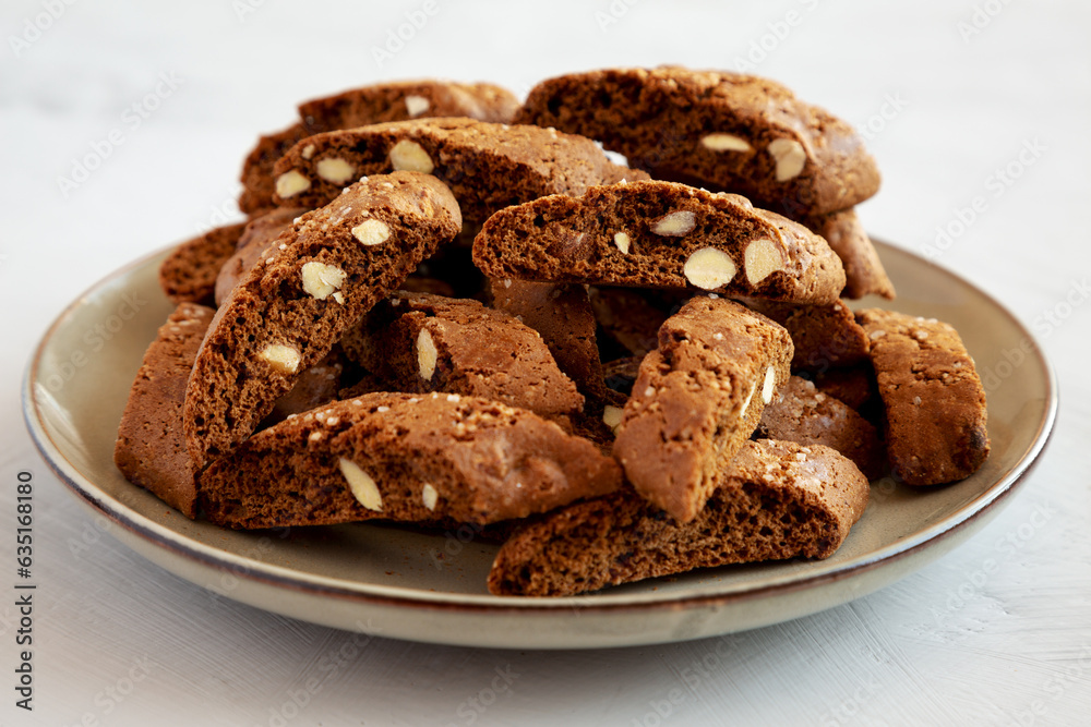 Homemade Italian Cantuccini with Almond and Coffee on a Plate on a gray surface, side view. Crispy Almond and Coffee Cookies.