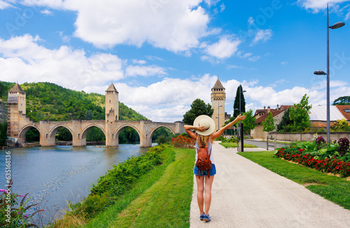 Woman traveling in France-Lot, Cahors city landscape with river and bridge