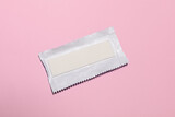 Unwrapped stick of tasty chewing gum on pink background, top view