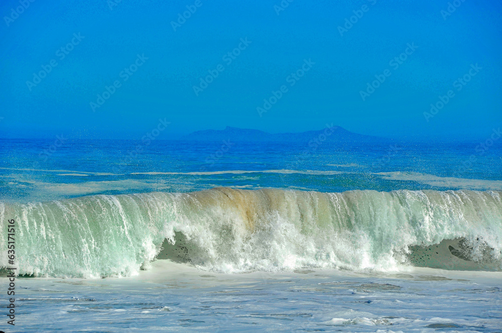 powerful cross ocean wave breaking during the day on the beach powerful cross ocean wave breaking during the day on the beach