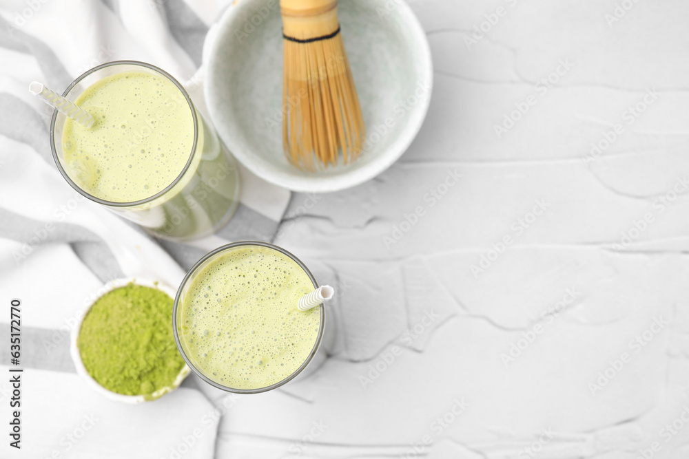 Glasses of tasty matcha smoothie on white textured table, flat lay. Space for text Glasses of tasty matcha smoothie on white textured table, flat lay. Space for text